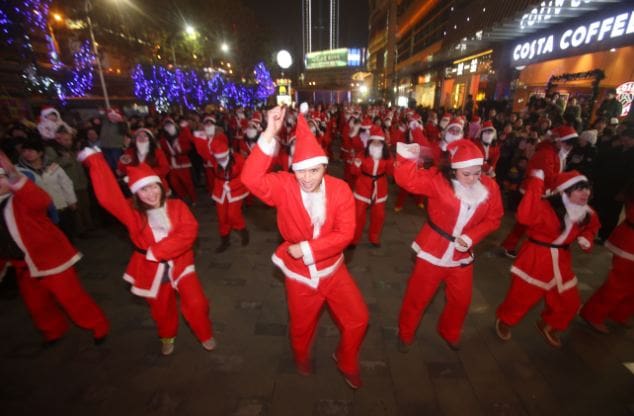 WUHAN, CHINA - DECEMBER 24: People dressed as Santa Claus dance 'Gangnam Style' on Christmas Eve on December 24, 2012 in Wuhan, Hubei Province of China. PHOTOGRAPH BY China Foto Press / Barcroft Media UK Office, London. T +44 845 370 2233 W www.barcroftmedia.com USA Office, New York City. T +1 212 796 2458 W www.barcroftusa.com Indian Office, Delhi. T +91 11 4053 2429 W www.barcroftindia.com